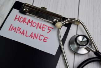 Hormones Imbalance write on sticky notes isolated on office desk